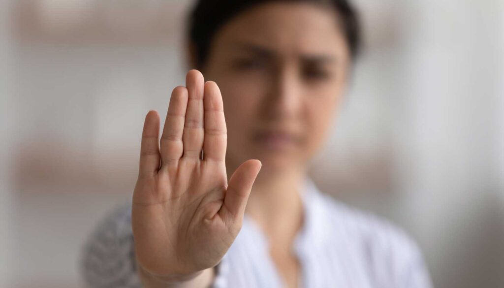 lady raising hand telling abuser to stop
