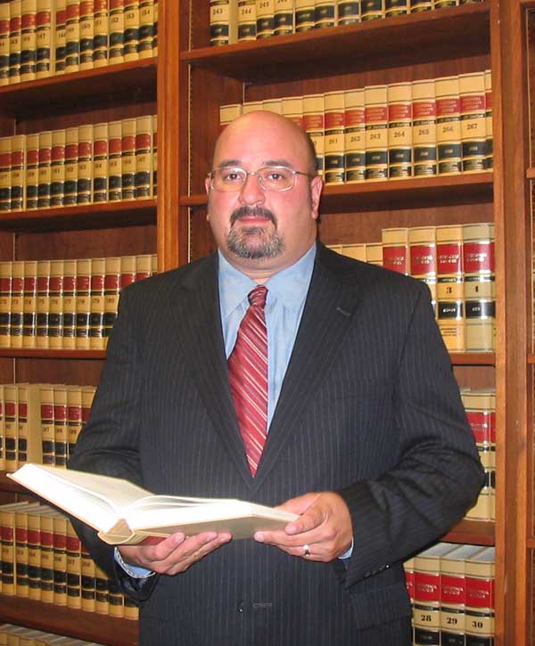 Charles Green Divorce lawyer Charles M. Green in front law library